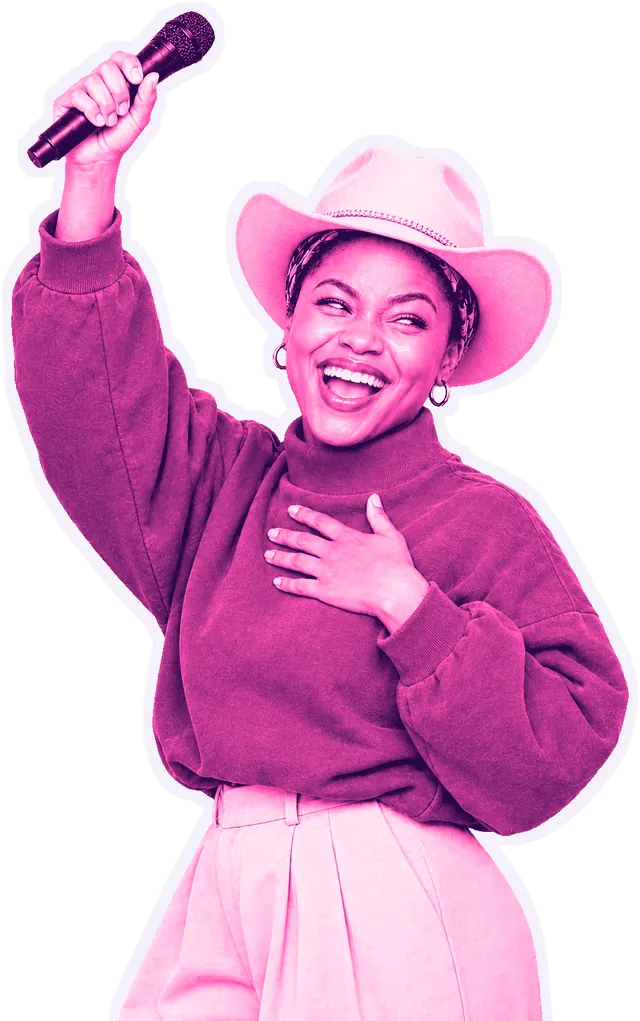 MC Bella laughing, microphone raised high, in her pink cowboy hat